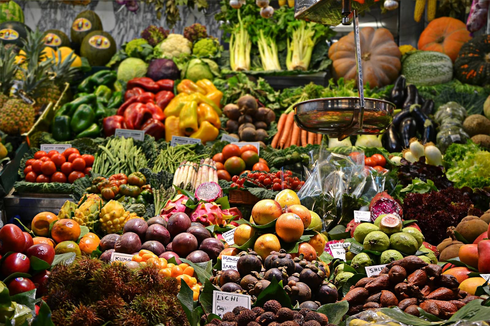 Open produce market with stacked goods